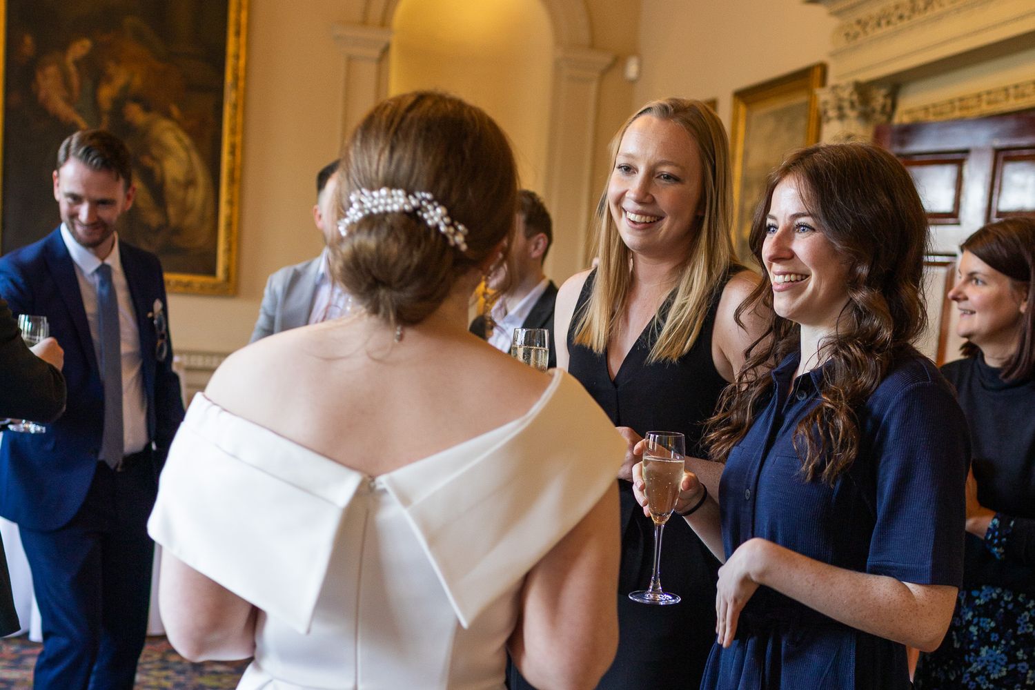 Wedding celebration in an elegant room with guests mingling and toasting after small Dublin City wedding.