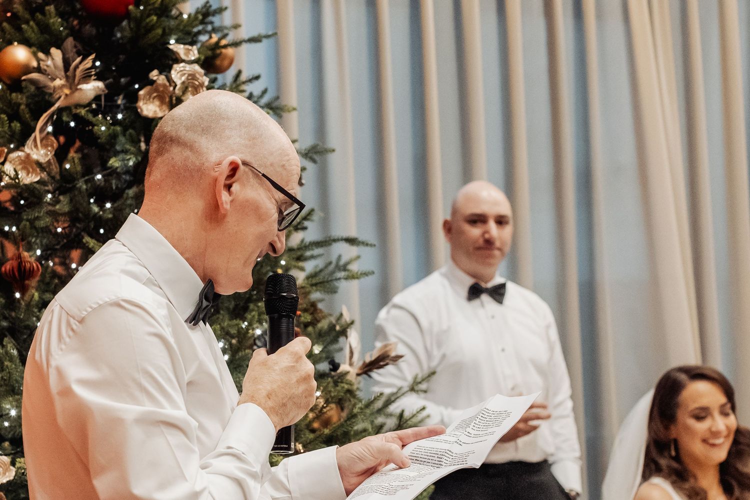 Wedding reception celebration with Christmas decorations and festive lighting.