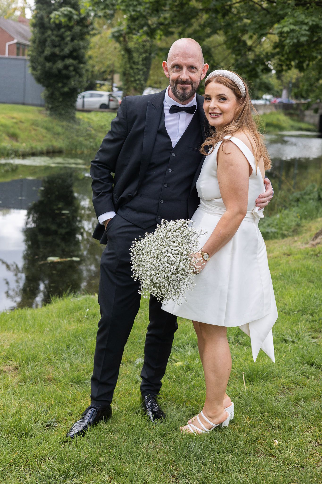 Dublin registry office couple standing at Dublin CIty Canal for photo.