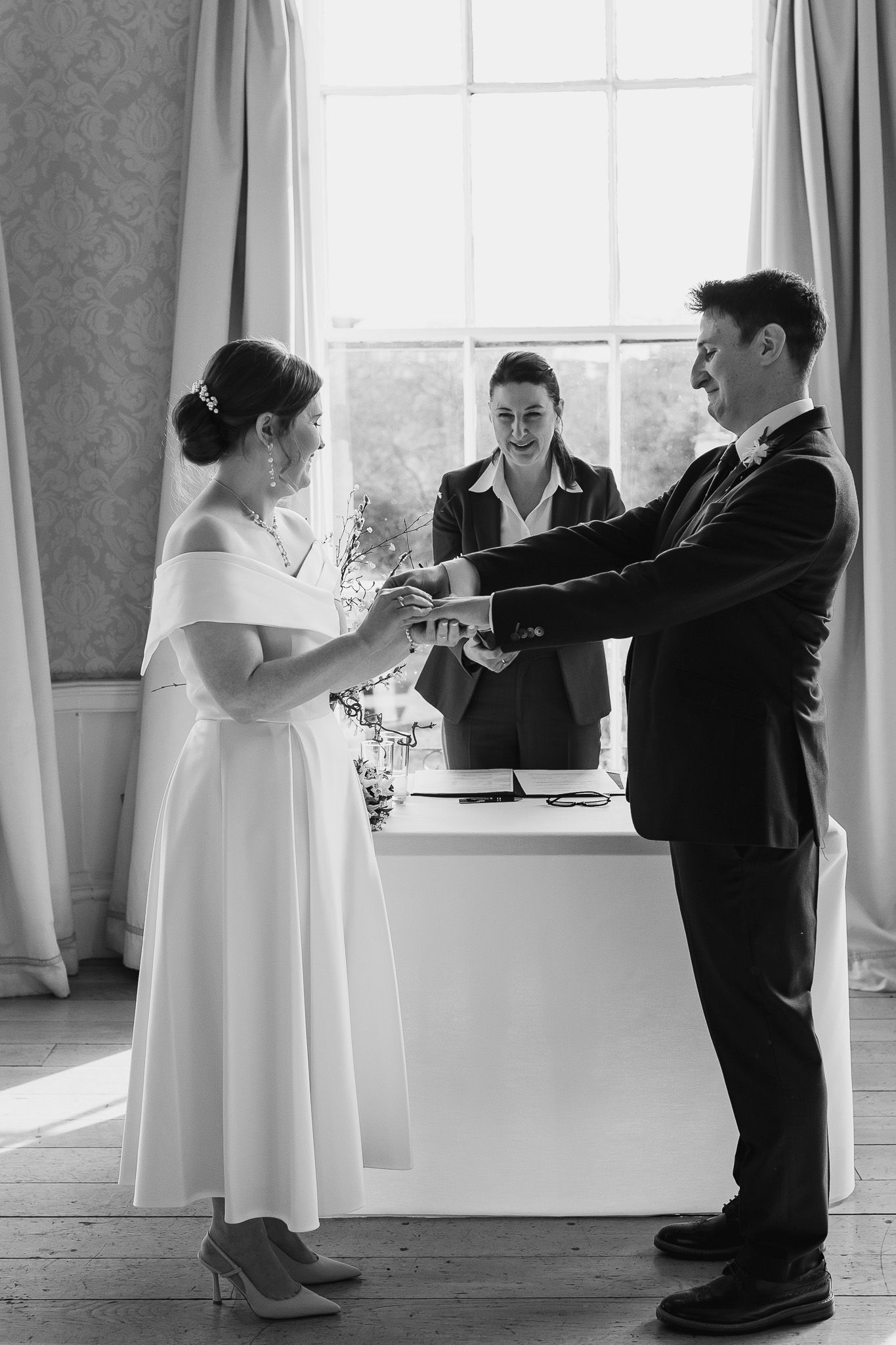 Black and white photos of couple sharing playful moments during Dublin wedding ceremony.