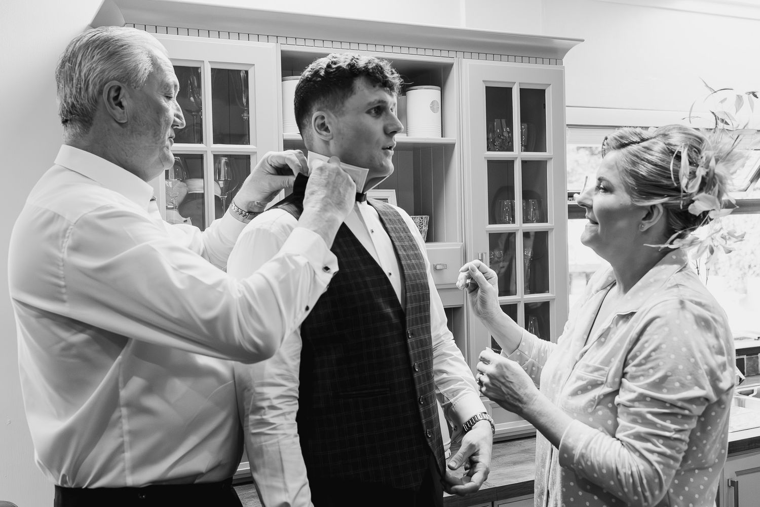 Black and white photo of people helping with wedding preparations in a Dublin Kitchen.