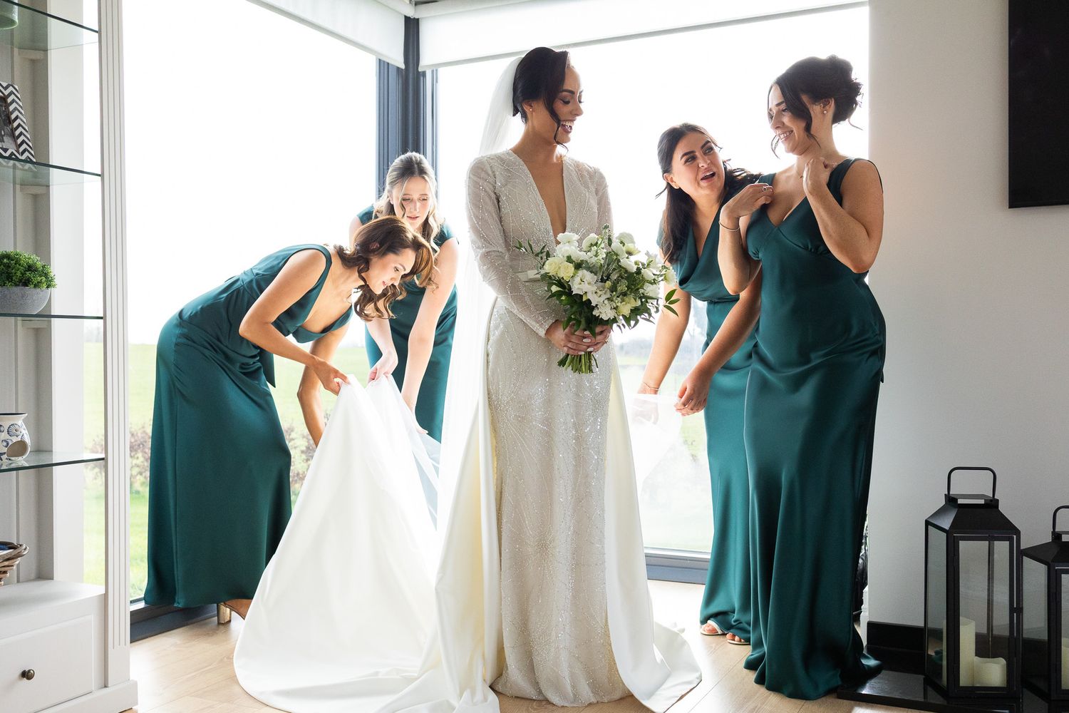 Wedding party in emerald green dresses and white gowns gathered together at a Dublin city wedding.