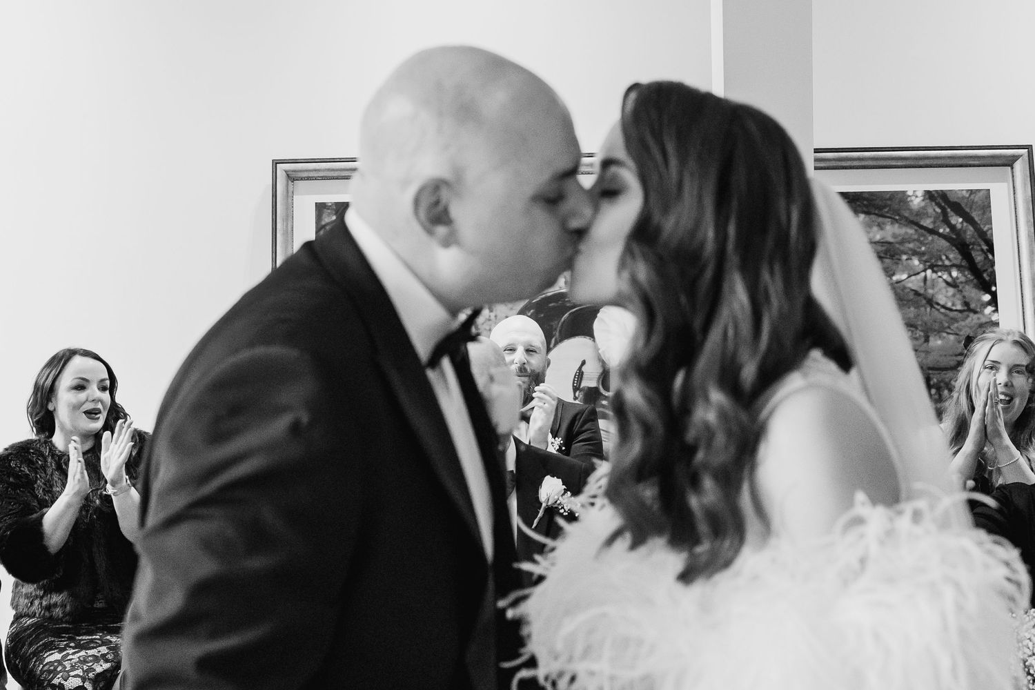 Black and white wedding photographs showing tender moments during an indoor celebration.