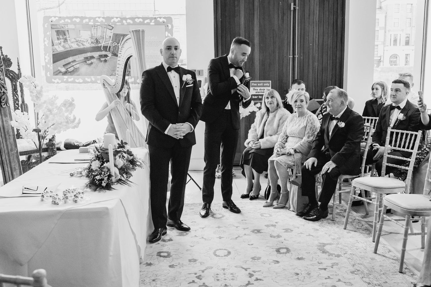 Wedding ceremony guests seated in rows during an indoor celebration.