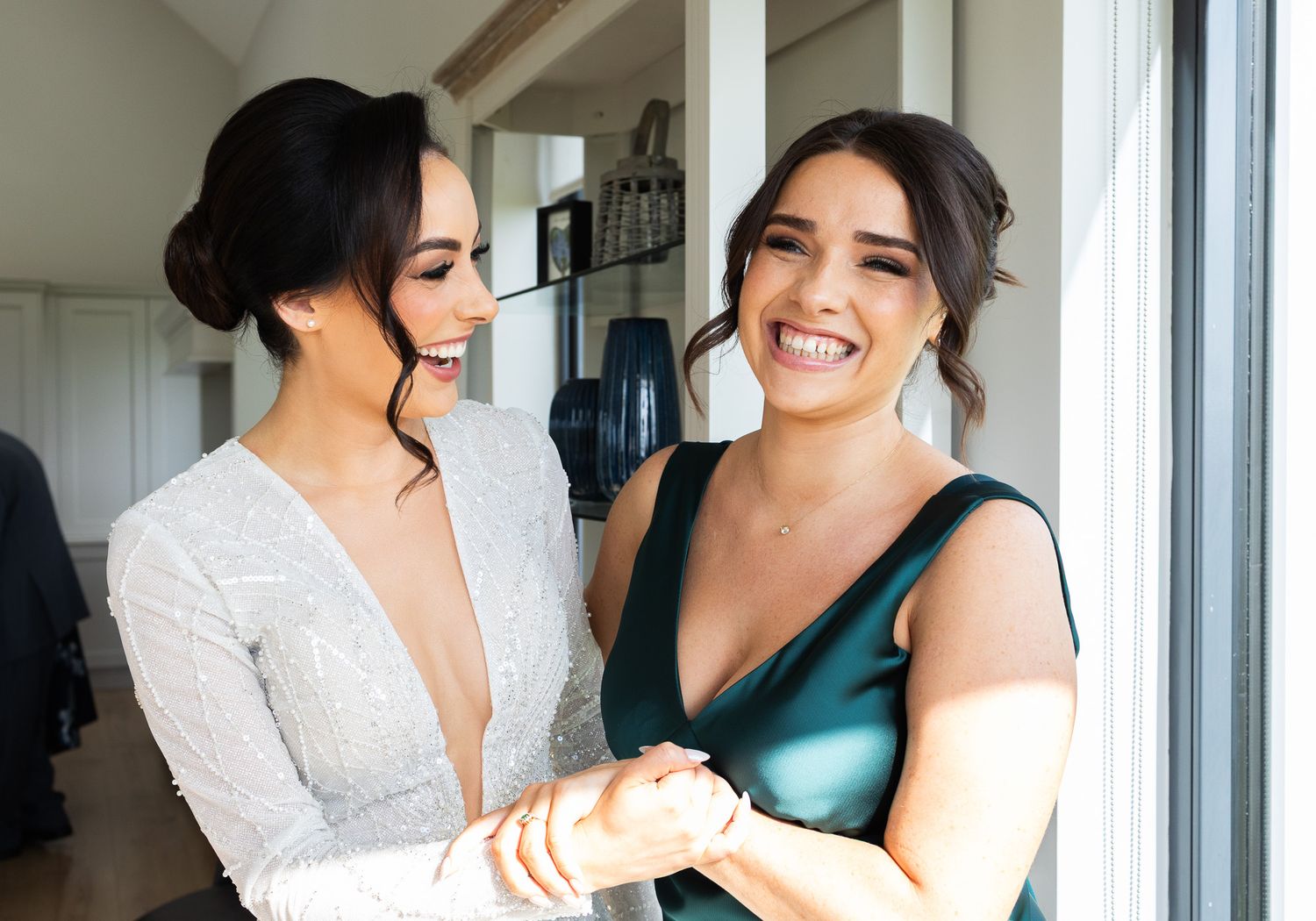 Bride sharing joyful moment by bright window captured by Dublin Weddings photography Laura Colon