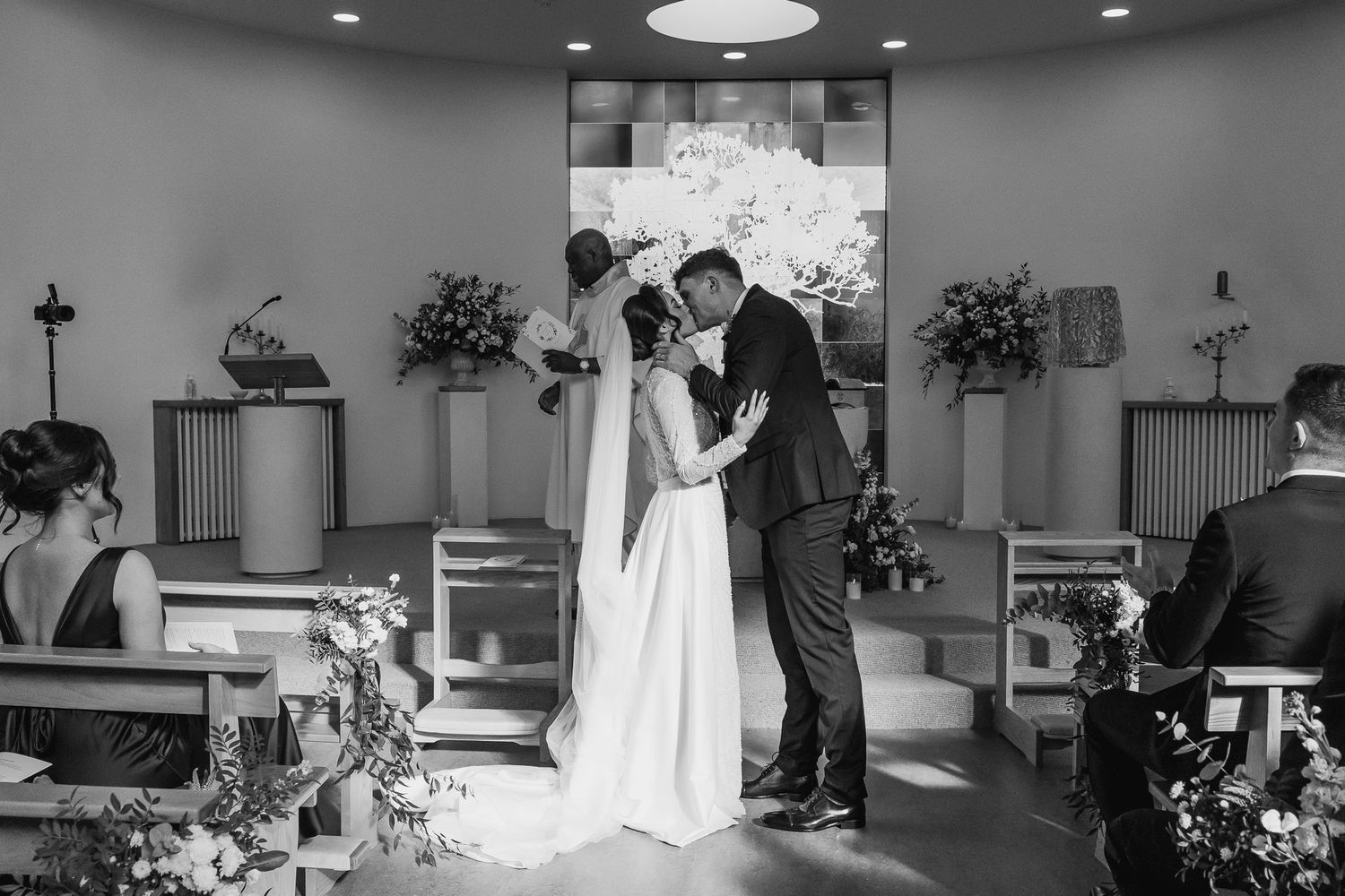 Black and white photo capturing the first kiss at a Dublin wedding, photographed naturally by Dublin wedding photographer Laura Conlon.