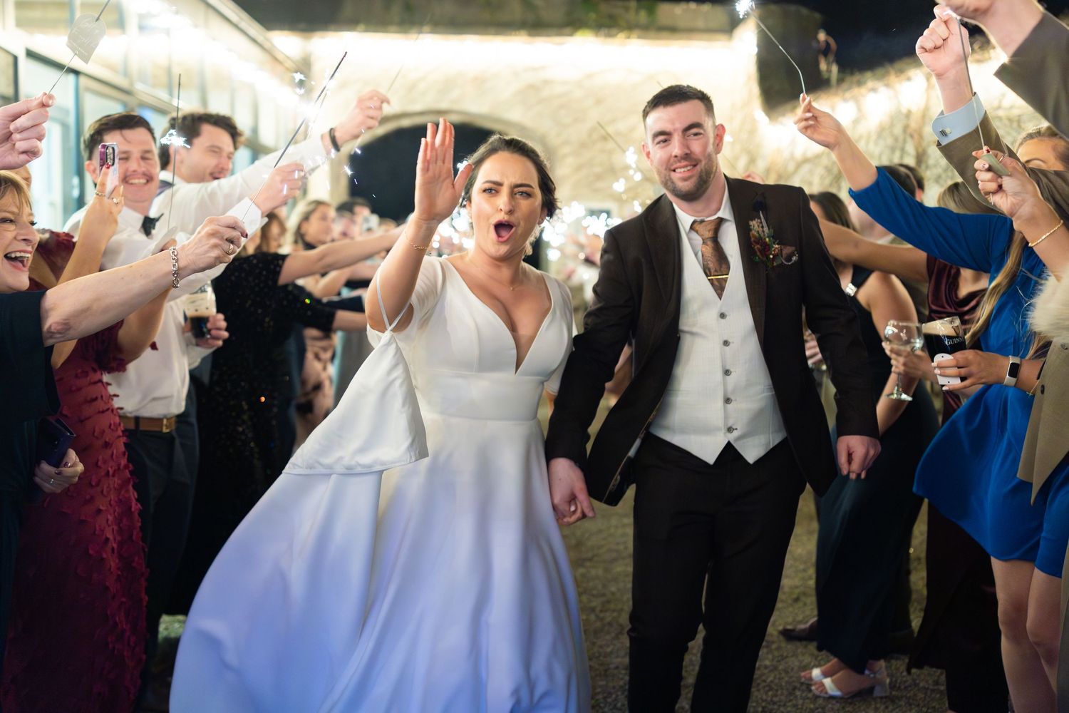 Wedding guests celebrate and dance together during a lively reception party.