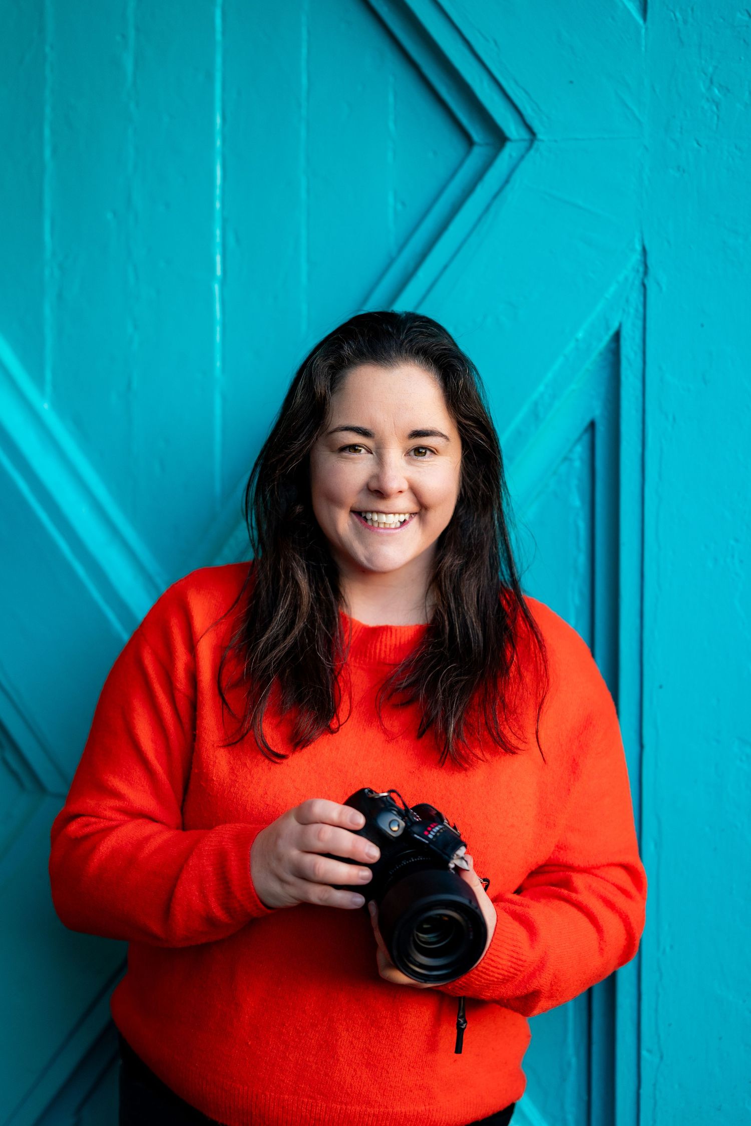 Portrait sequence showing Dublin wedding photographer Laura Conlon with camera against vibrant blue background.
