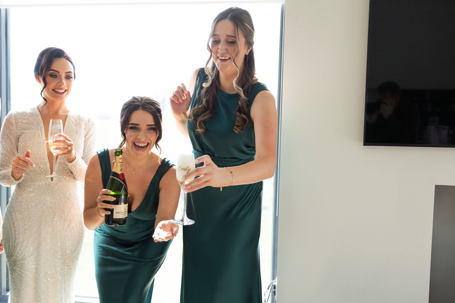 Wedding party members sharing joyful moments during pre Dublin City hall ceremony celebrations.