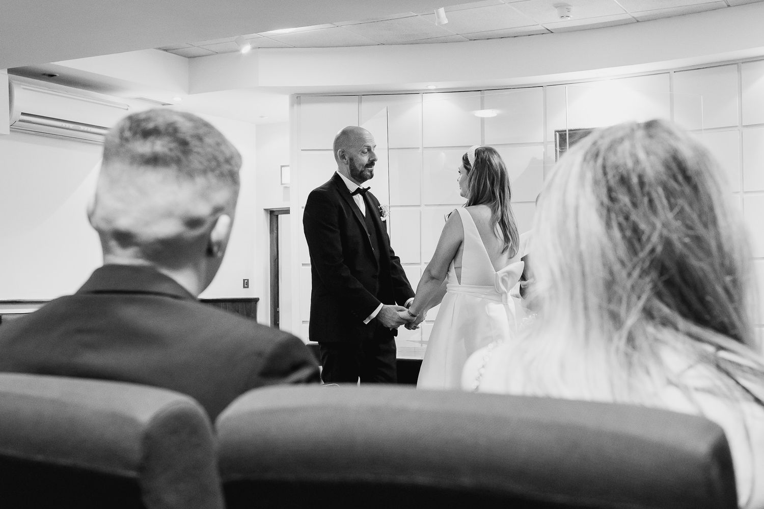 Wedding ceremony room of Dublin registry office with white walls and rows of seating.