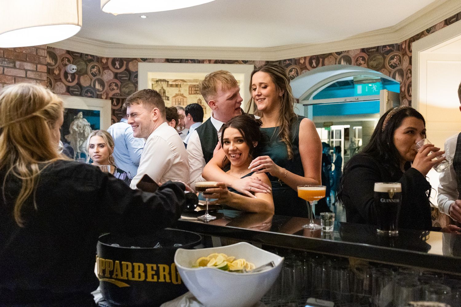 Party guests gathered around a bar counter with snacks during a Dublin City weddings