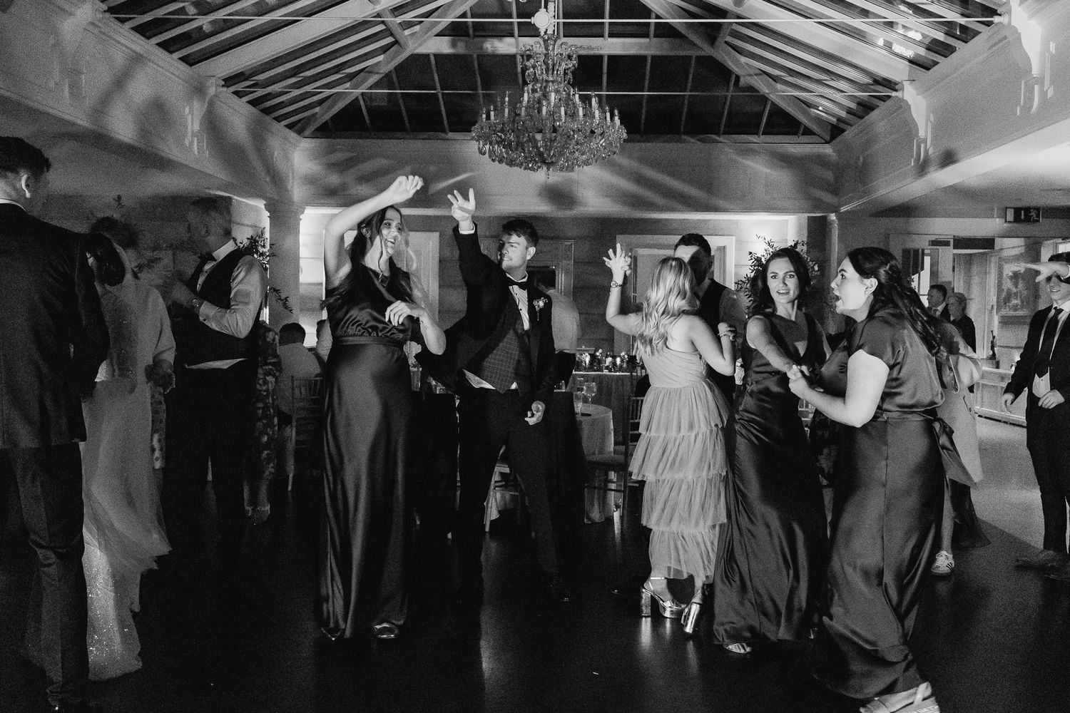 Black and white panoramic shot of wedding guests dancing at an evening reception in 25 Fitzwilliam Place.