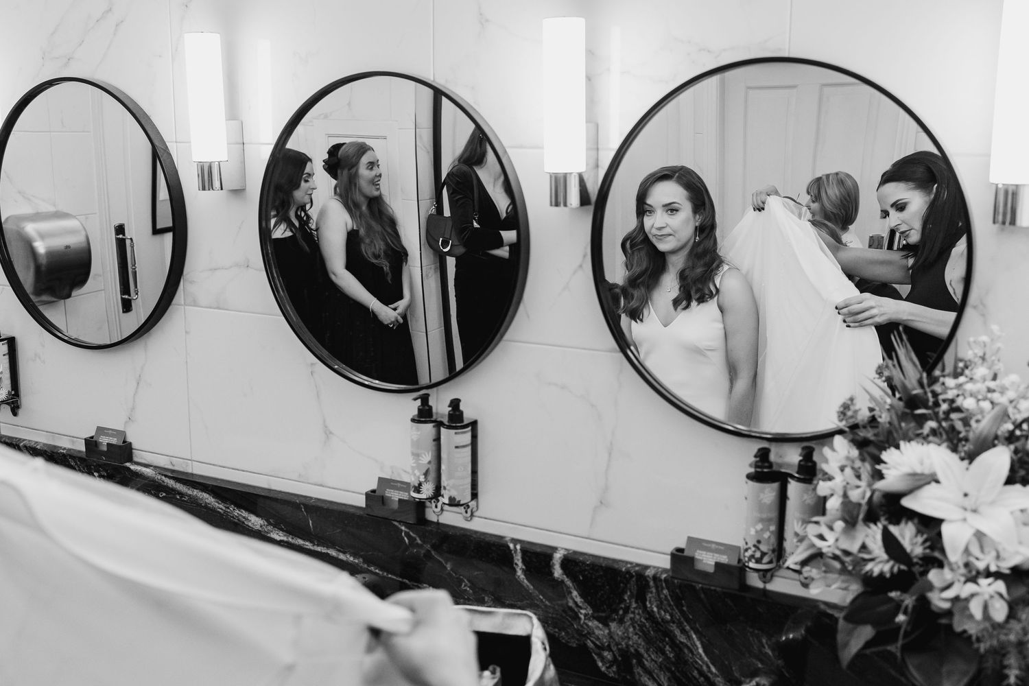 Wedding preparation area with mirrors and styling stations in bright room.