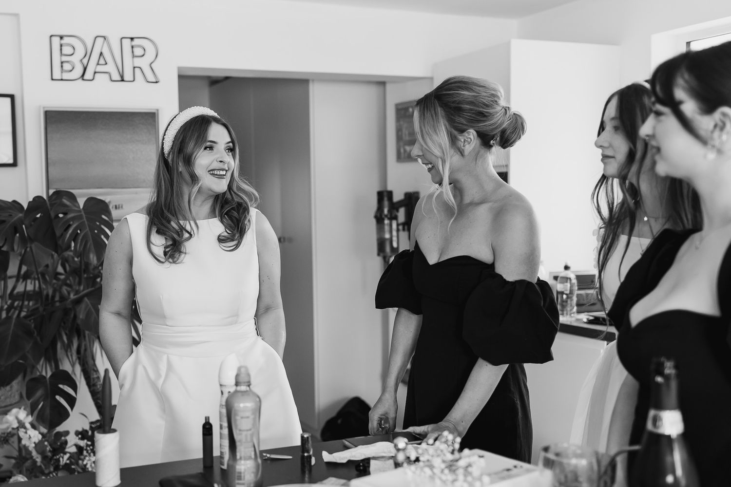 Wedding guests in formal attire socializing at a Dublin bar area.