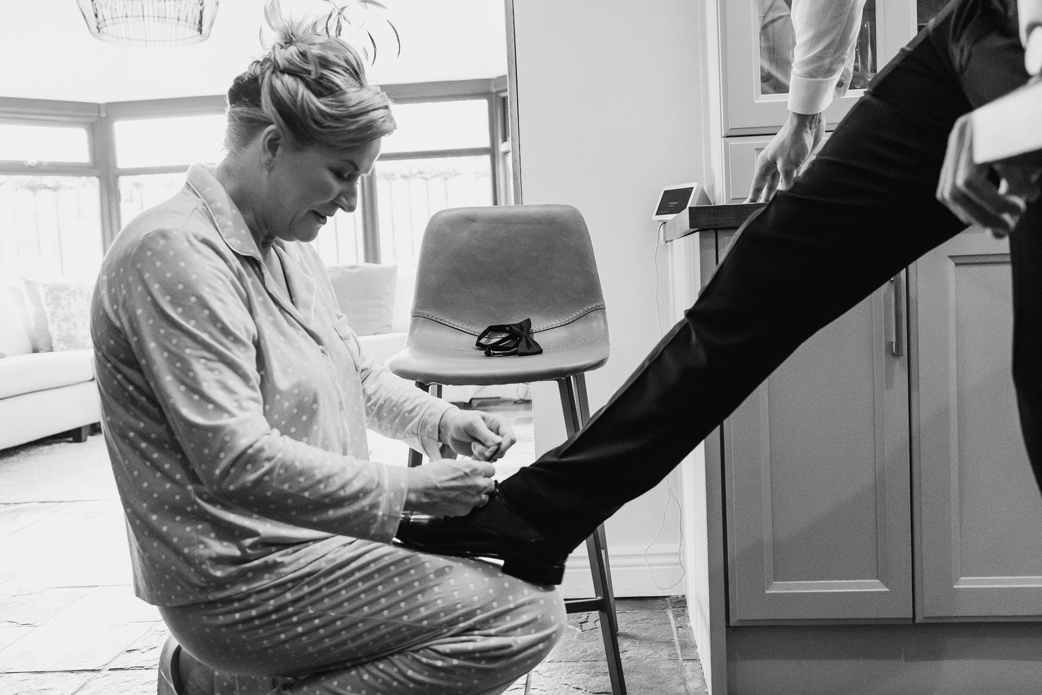 A formal shoe being polished during Dublin wedding day preparations.