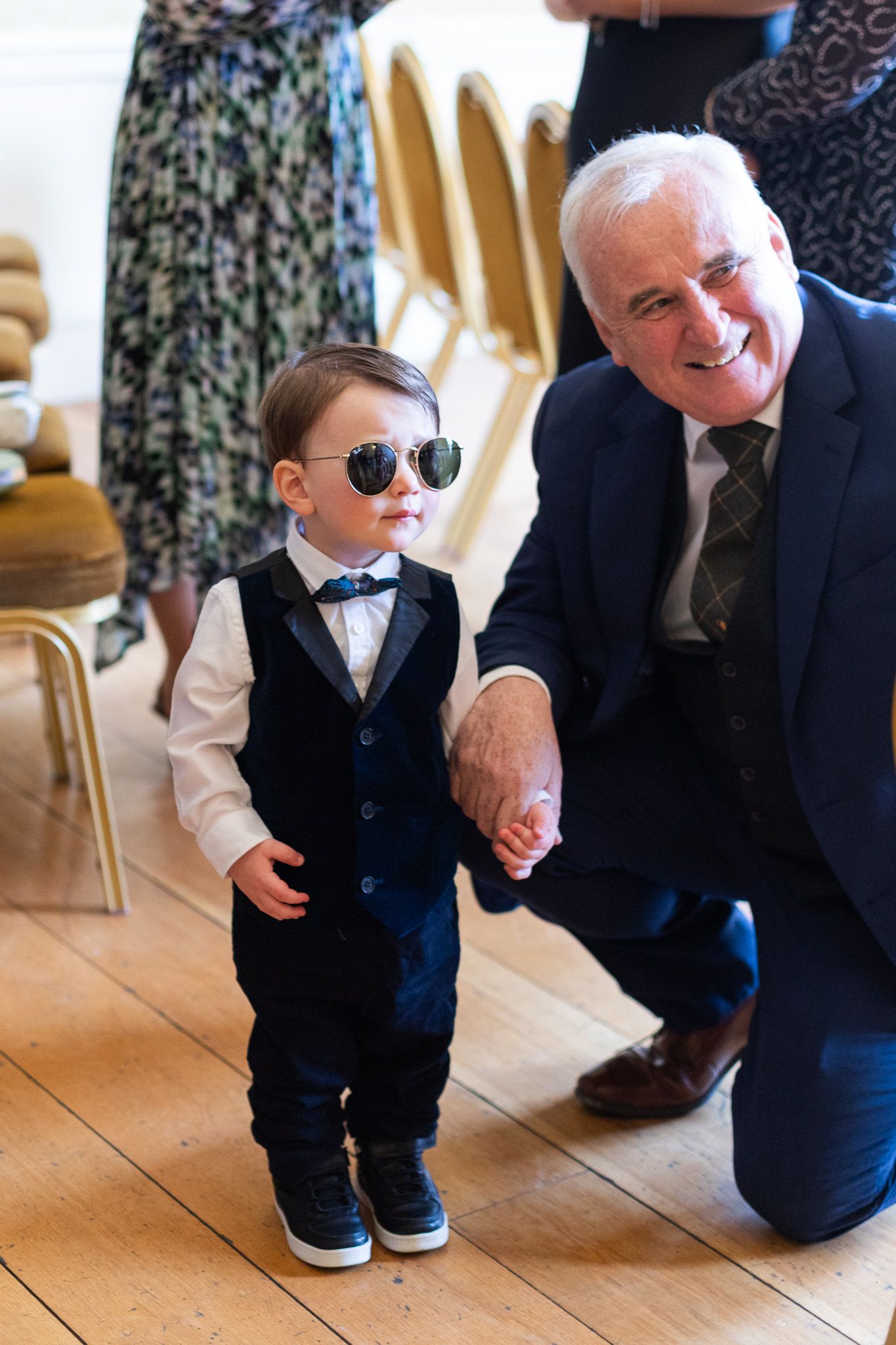 A young boy in a suit and sunglasses poses with an older gentleman at Dublin wedding in MoLI