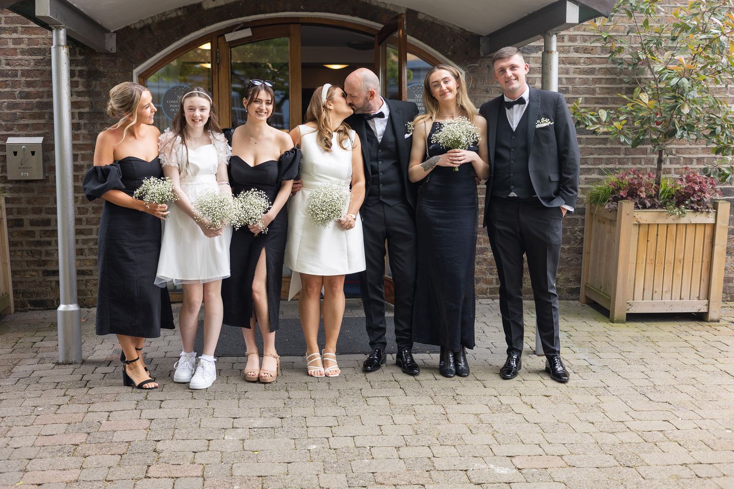 Wedding party members pose together at Dublin Reg office for a group photo.