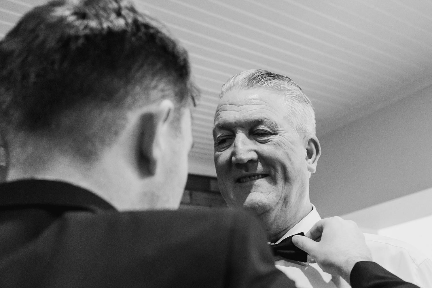 Black and white candid moment during wedding preparations indoors. Candid weddings photos in dublin.
