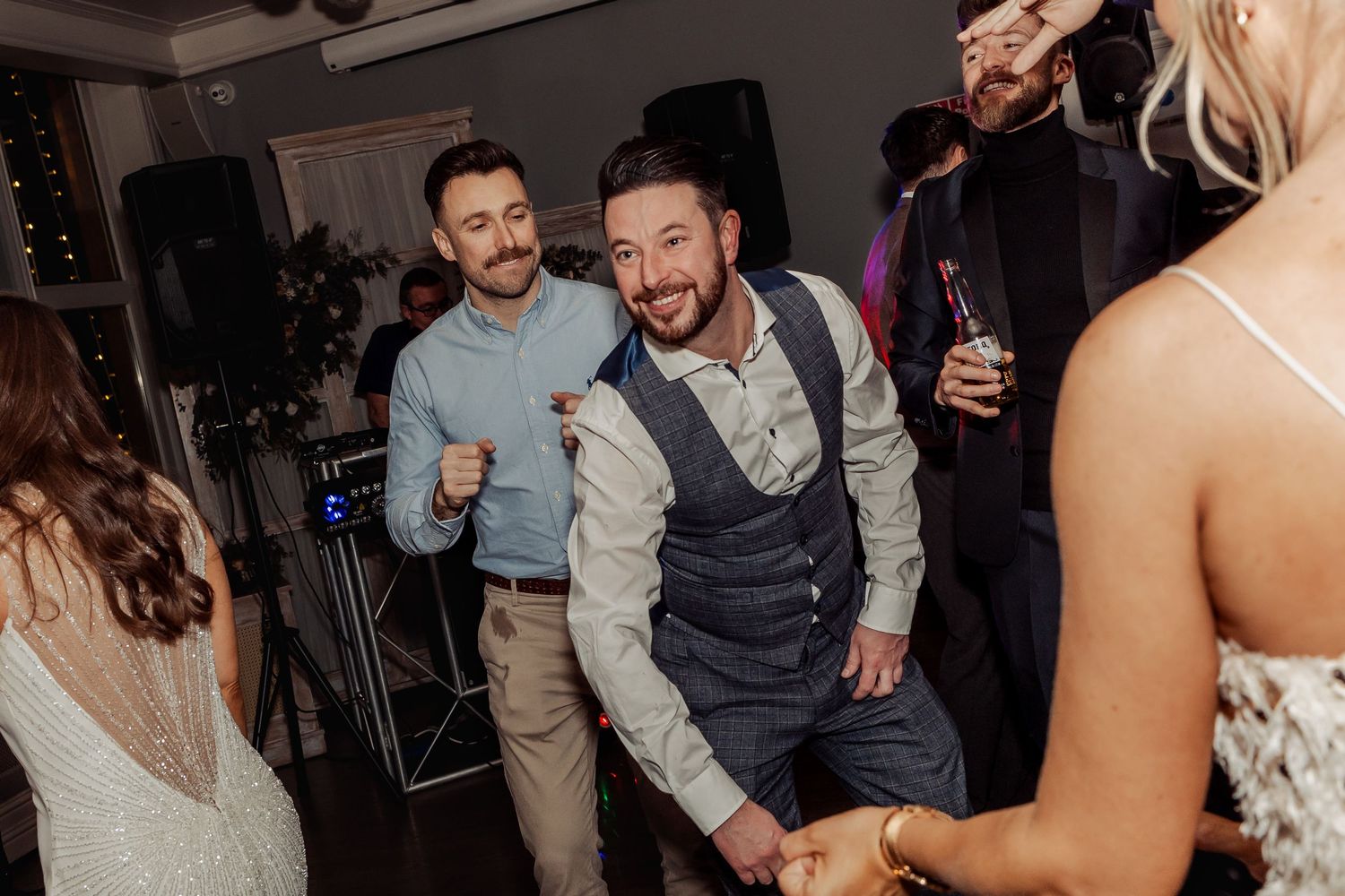 Candid moments of wedding guests dancing and celebrating at reception.