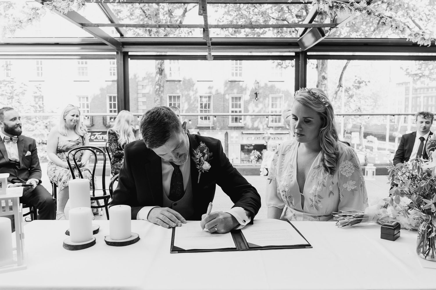 Black and white photo taken by Laura Conlon Dublin weddings photographer of wedding guests mingling during Dublin outdoor reception.