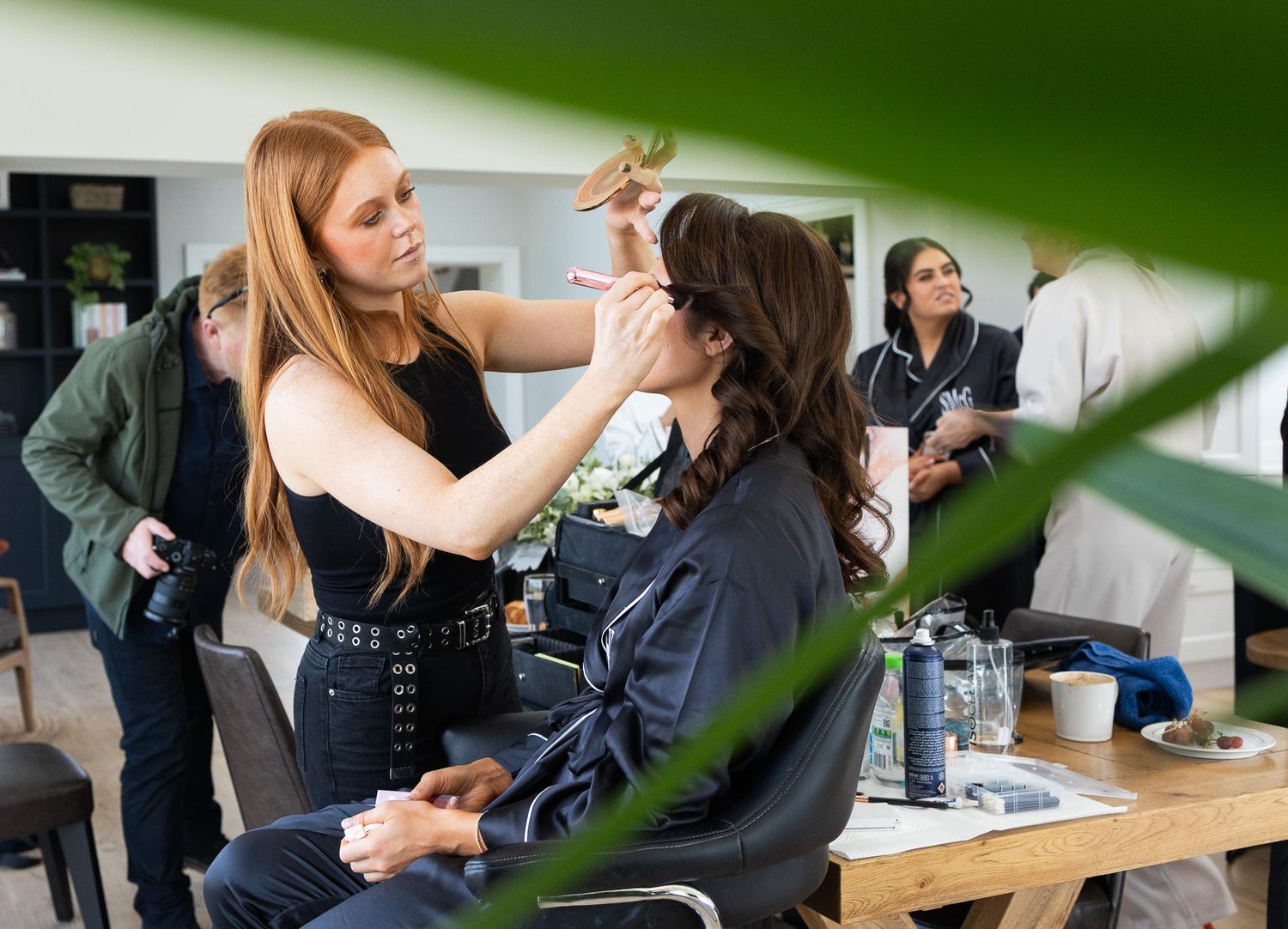 Professional makeup artists working on bridesmaid, photo by Laura Conlon the dublin wedding photographer.