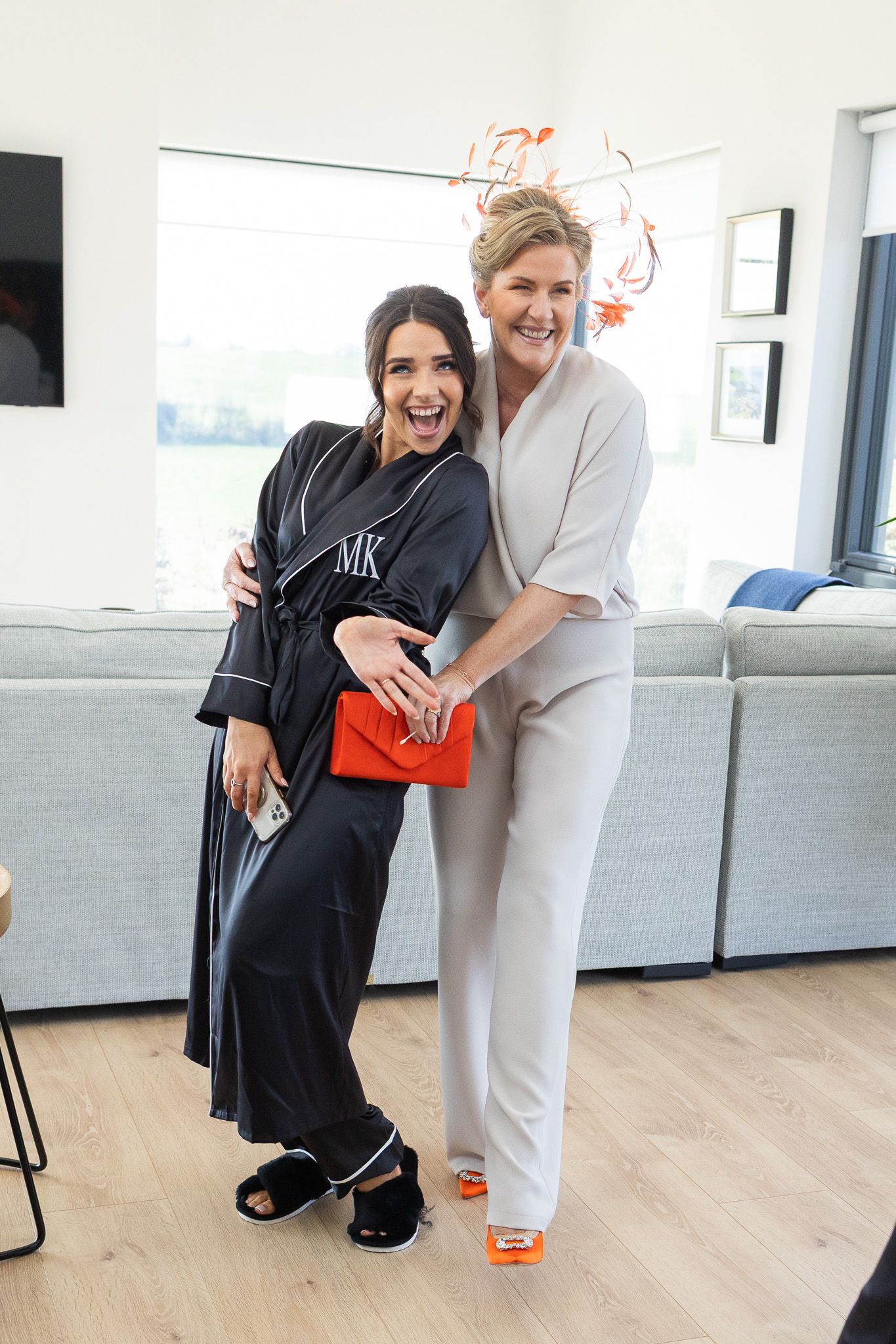 Two people in contrasting loungewear sharing a joyful moment in modern living room during Dublin city wedding
