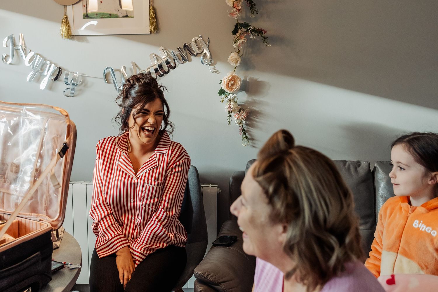 Group of people laughing and enjoying conversation at a social gathering.