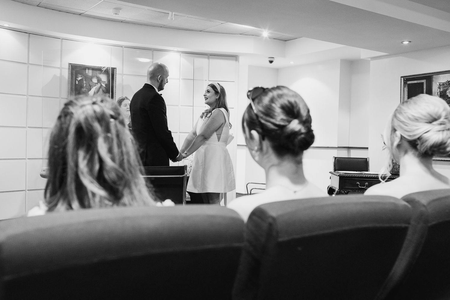 Wedding venue interior showing rows of seating from various angles.