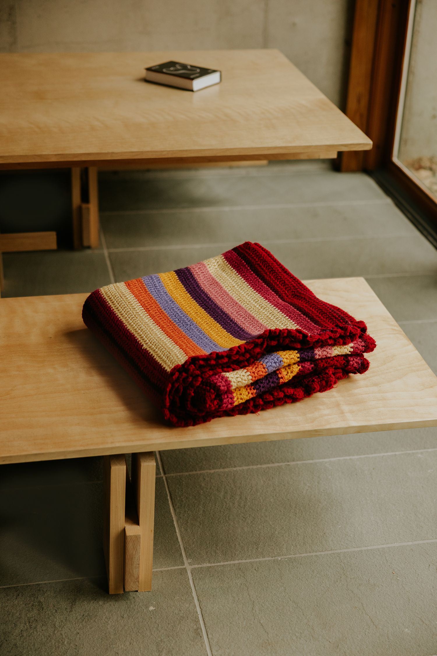 blanket on a bench in a home in the catskills, shot by Dylan Spangler