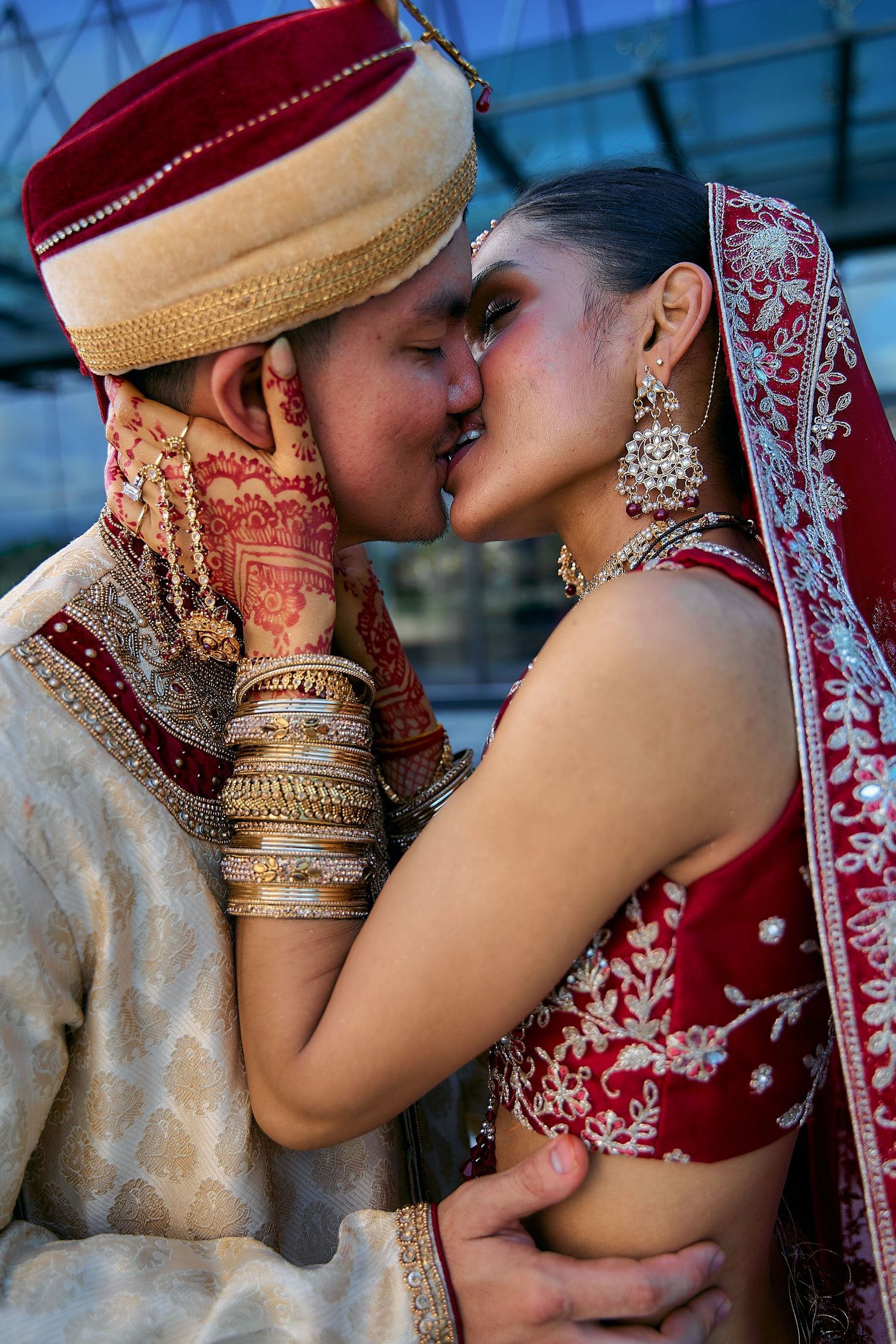 Close-up shots of a couple in traditional Indian wedding attire sharing intimate moments.