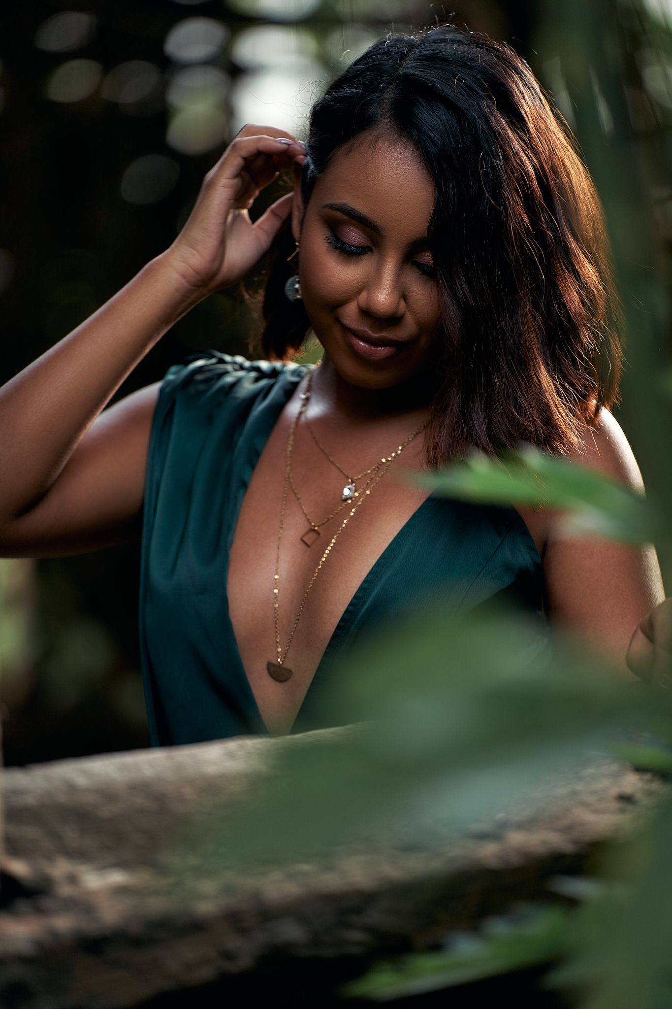 Intimate portrait series through leaves with soft natural lighting.
