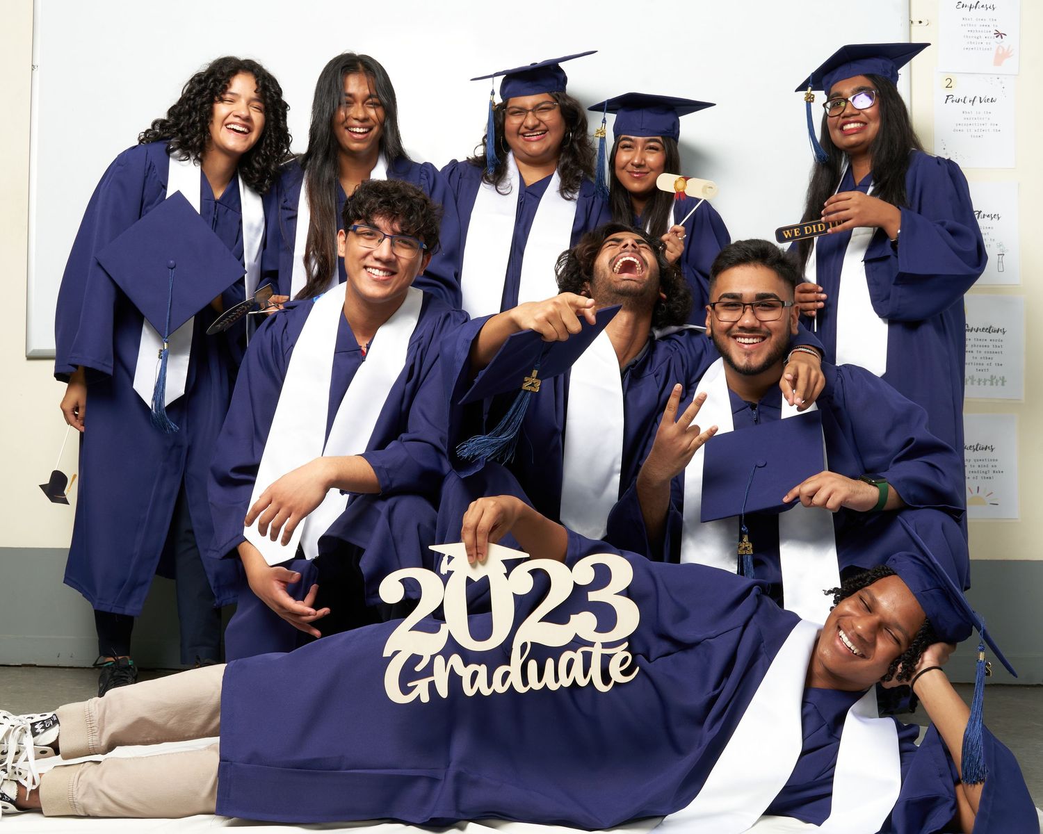 A collage of graduation photos showing students in navy blue caps and gowns posing together with 2023 decorations.