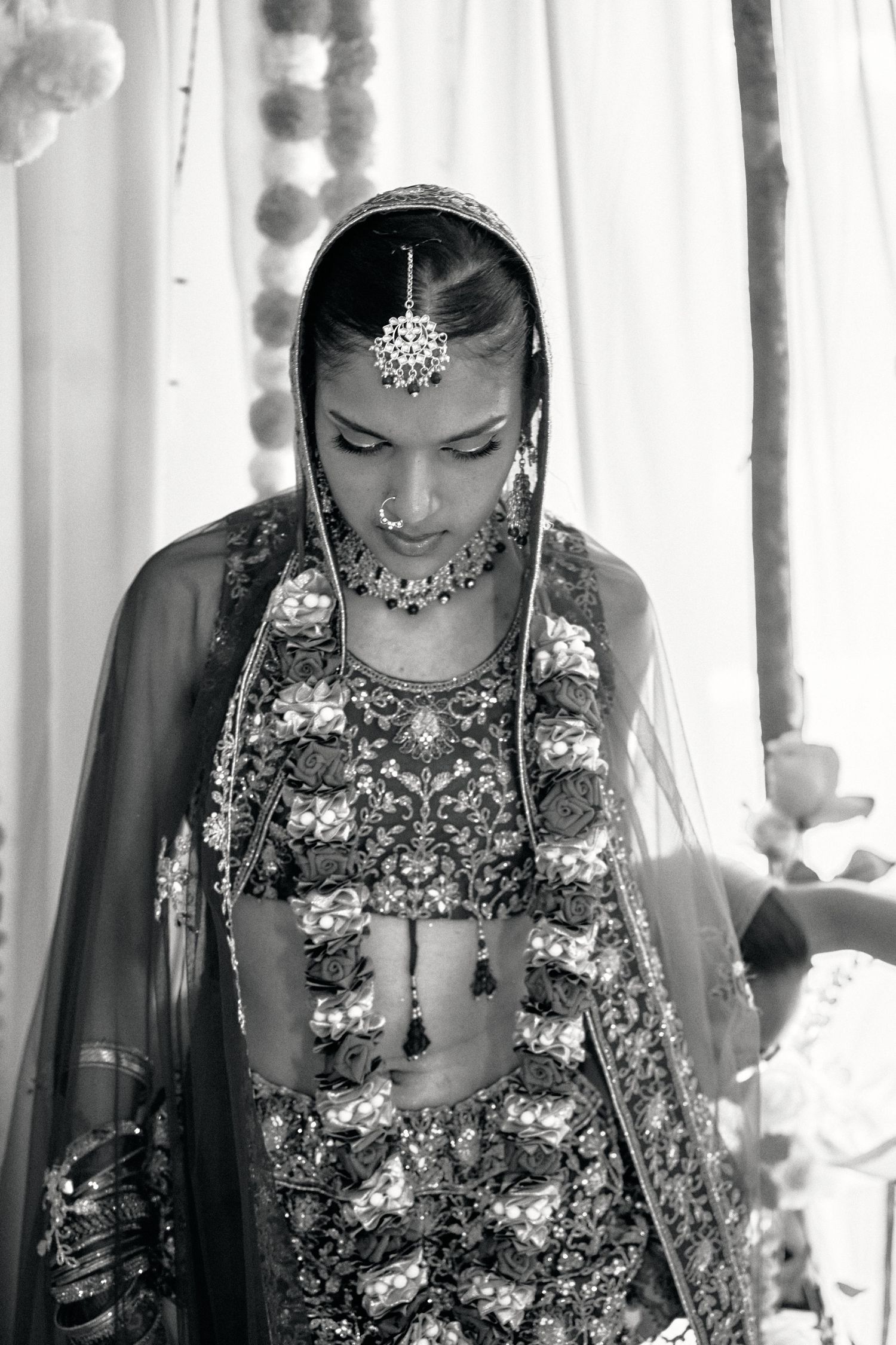 Black and white portraits capturing intimate moments during a traditional Indian wedding ceremony.