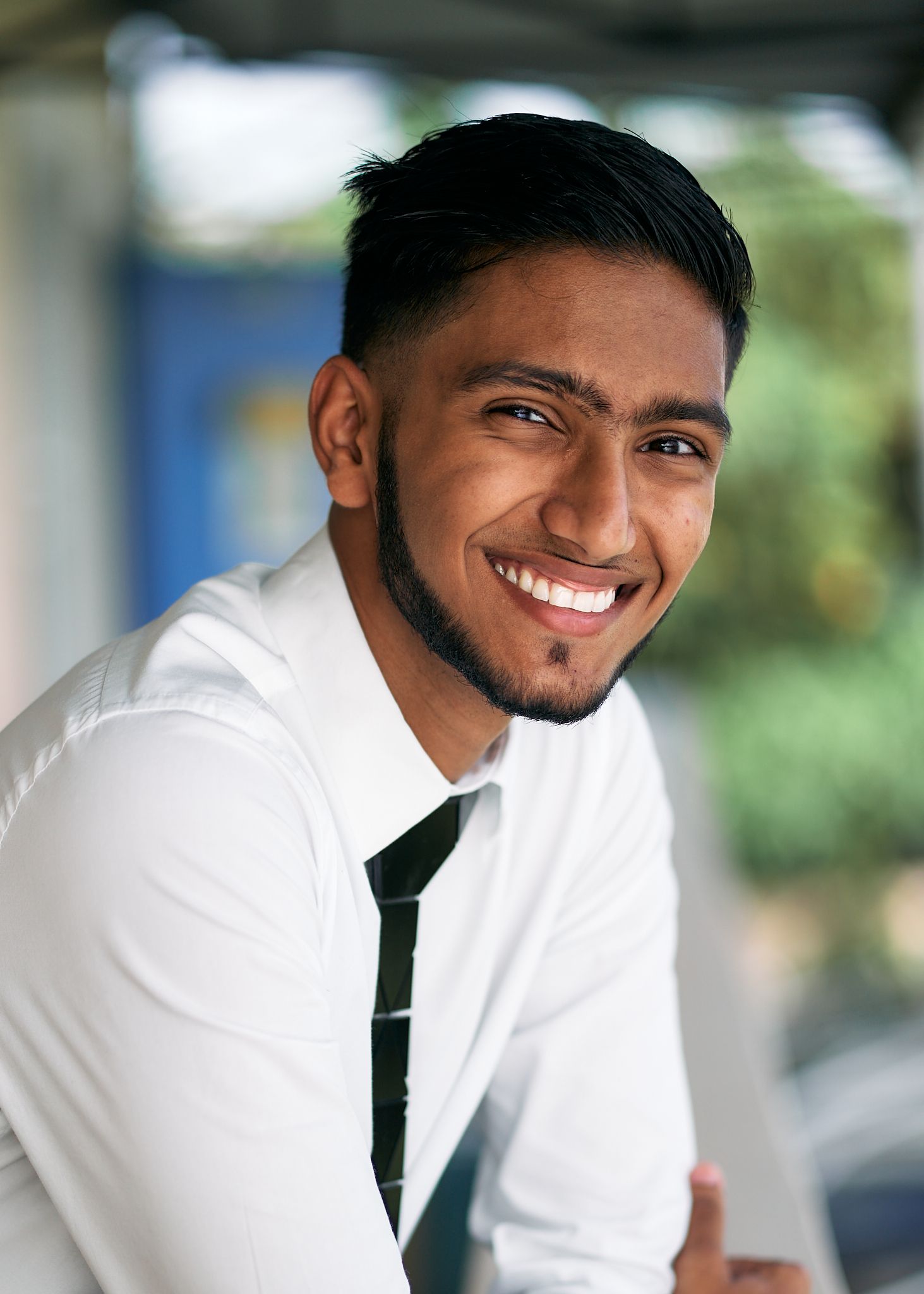 Professional headshot series showing a person in a white dress shirt and tie smiling against a blurred background.