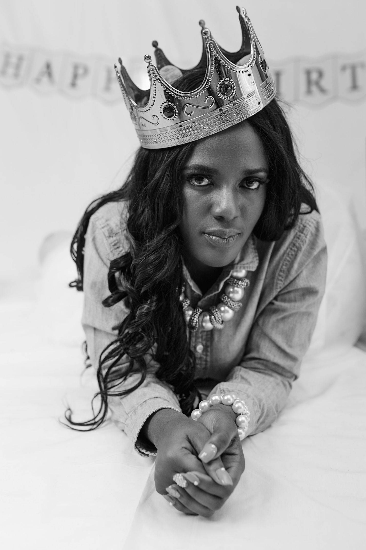 Black and white portrait series showing person wearing a decorative crown in artistic poses.