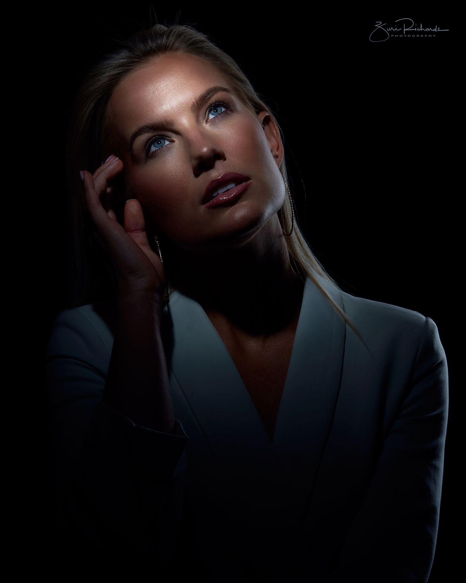 Dramatic portrait series in dark lighting with moody shadows and blue tones.
