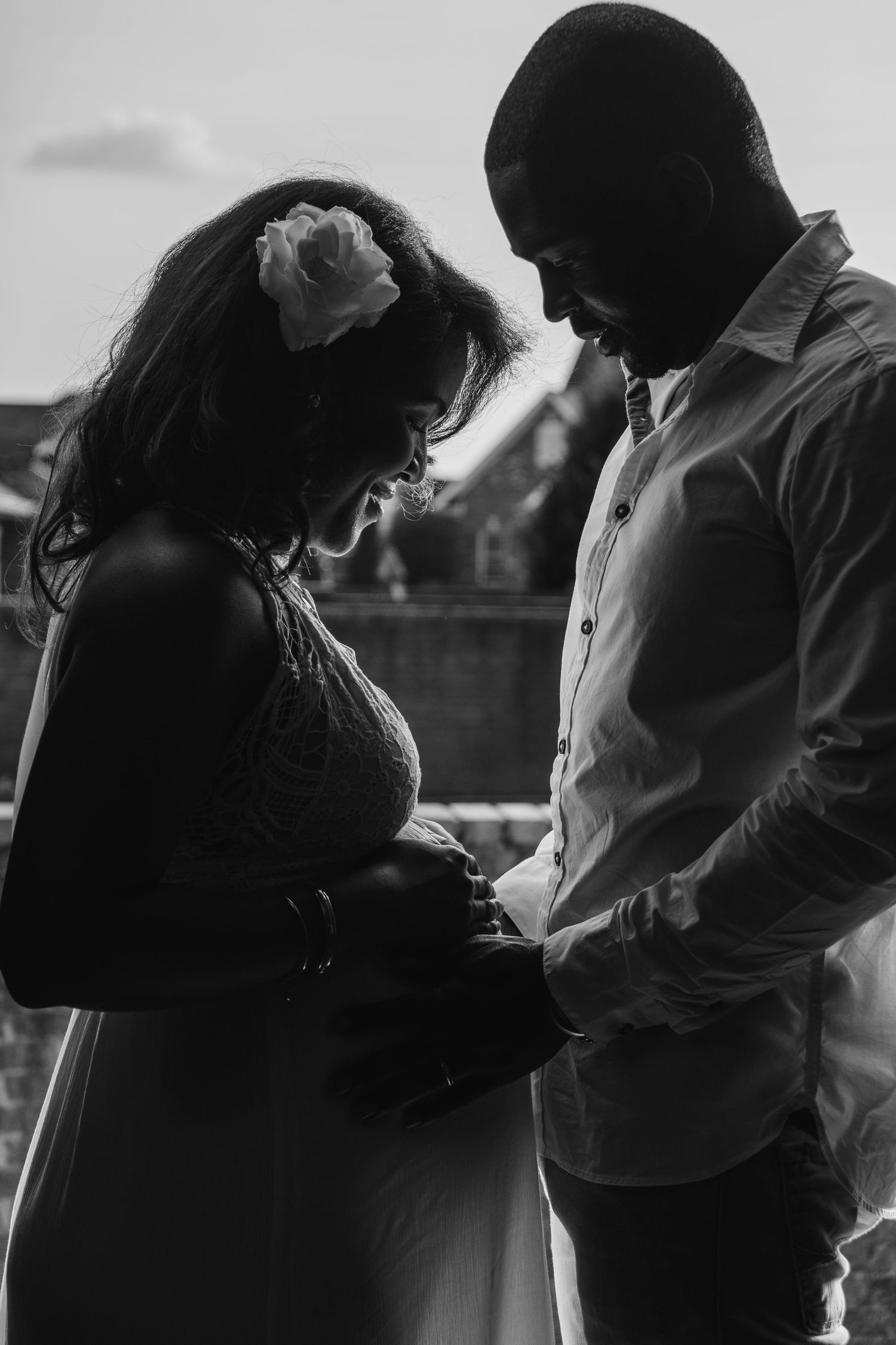 A romantic black and white photo series showing silhouettes of a couple embracing in tender moments.