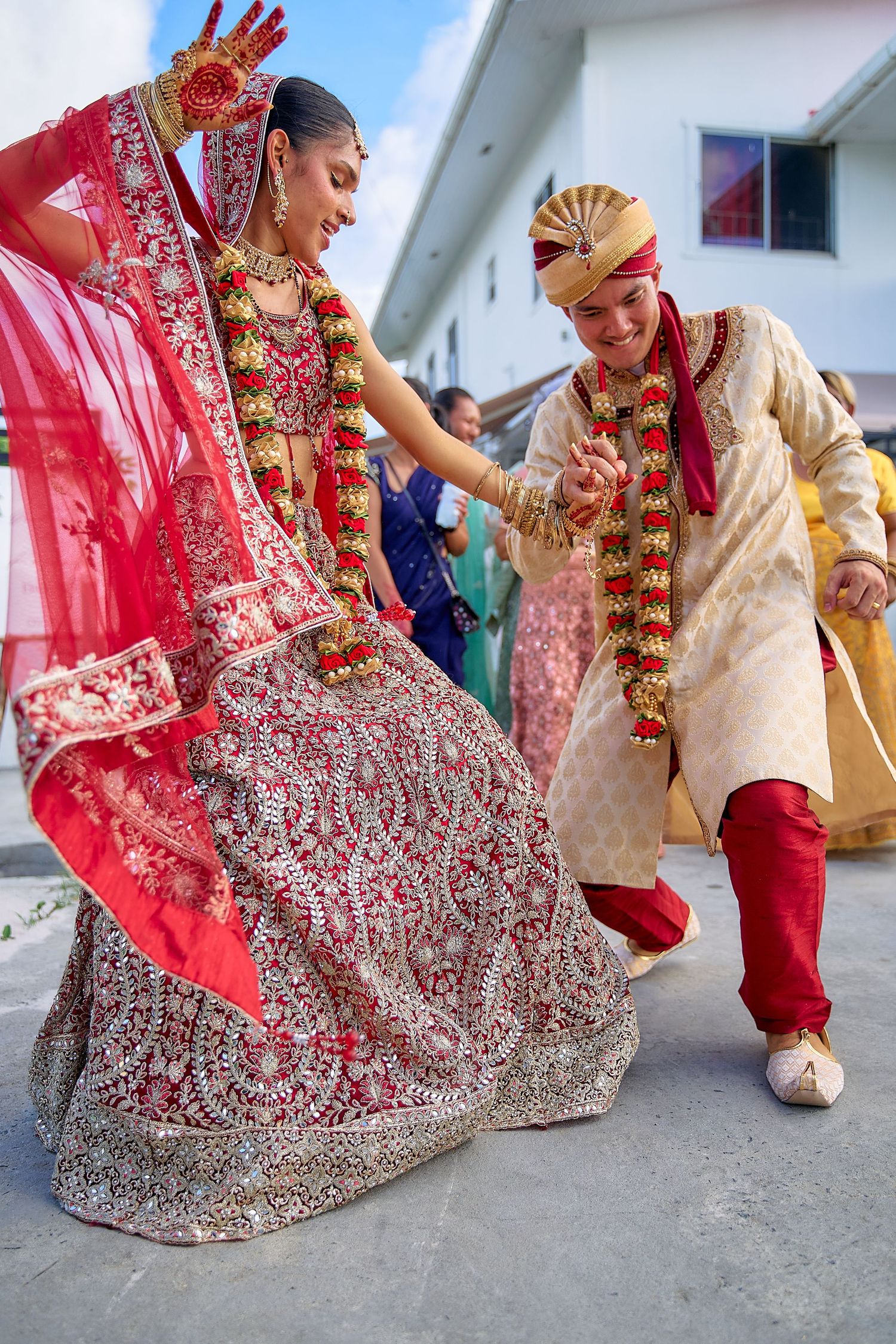 Ground-level shots showing movement of red bridal lehenga and traditional wedding attire during ceremony.