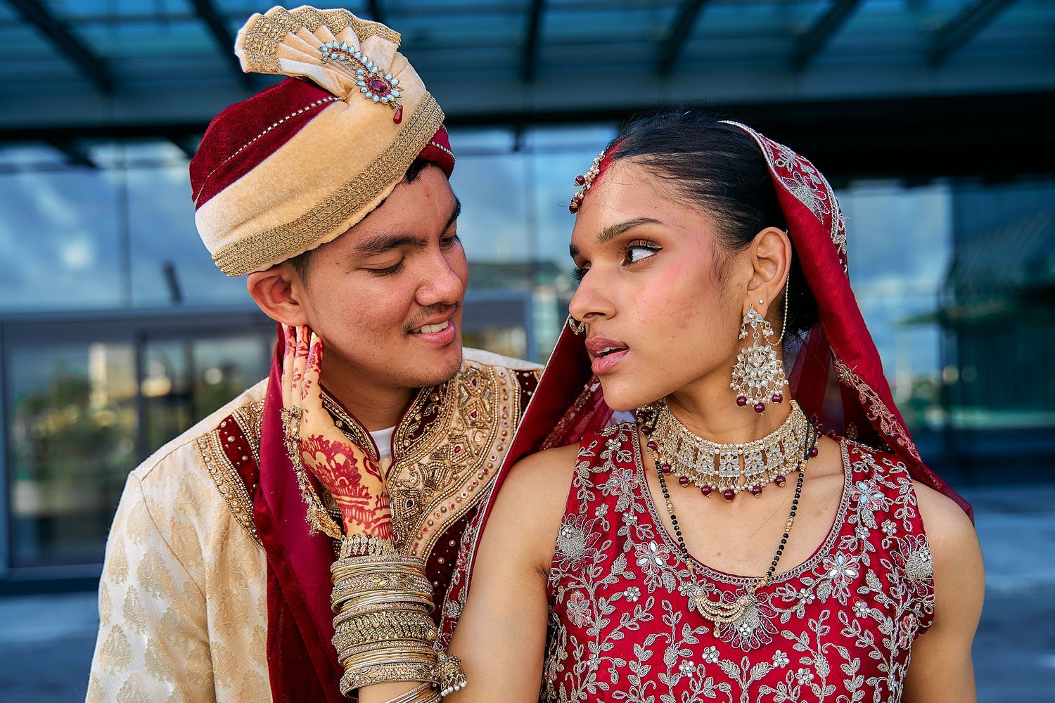 Series of romantic portraits showing couple in traditional Indian wedding attire against blue background.