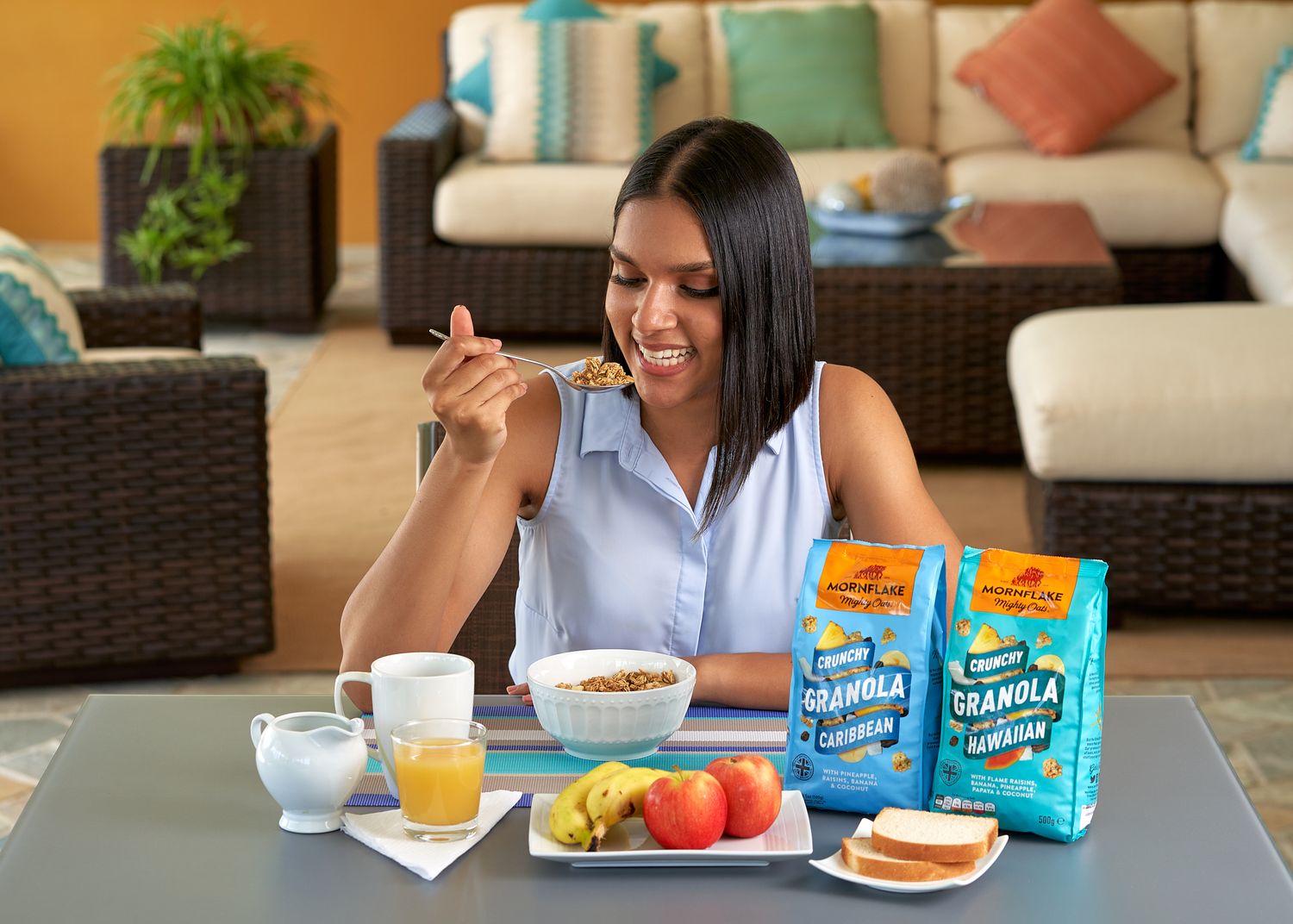 People enjoying breakfast with juice and snacks at outdoor patio furniture setting.
