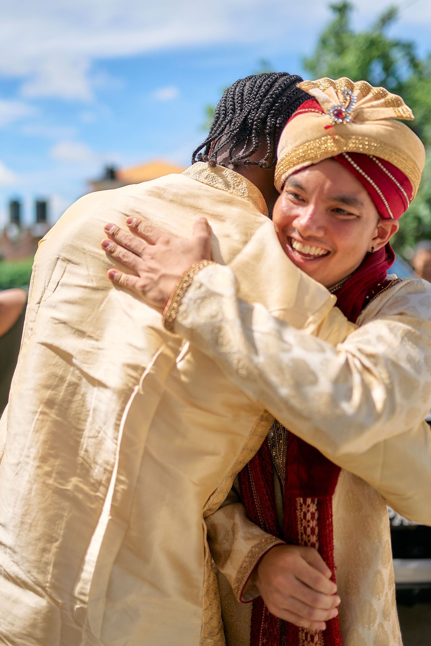 Candid outdoor shots of couple embracing in traditional Indian wedding attire.