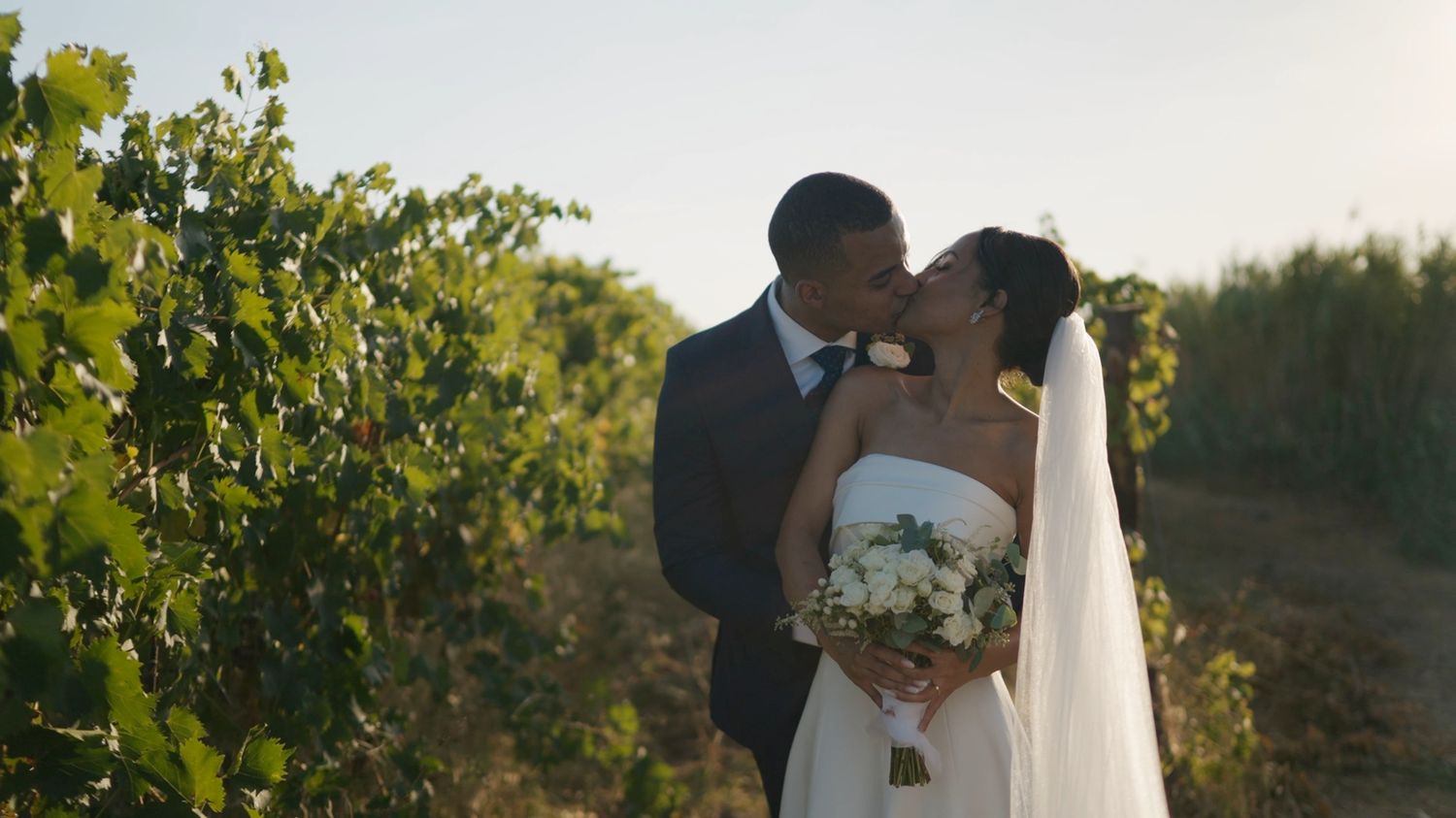 Julia & Felipe, bride and groom kissing among the vineyards during their elopement in Rome, Italy