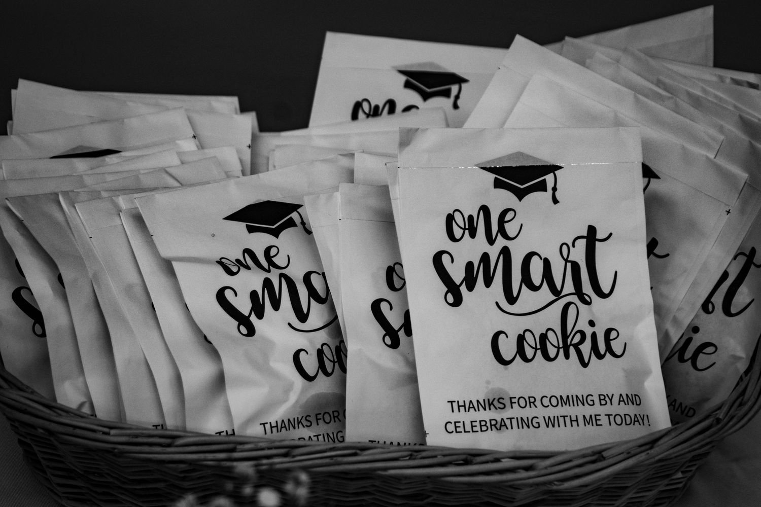 Collection of graduation-themed party favor bags and cards arranged in rows.