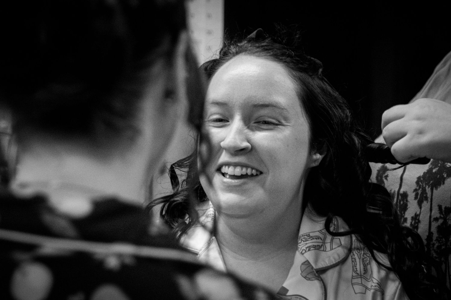 Candid black and white wedding moments showing joyful expressions and laughter.