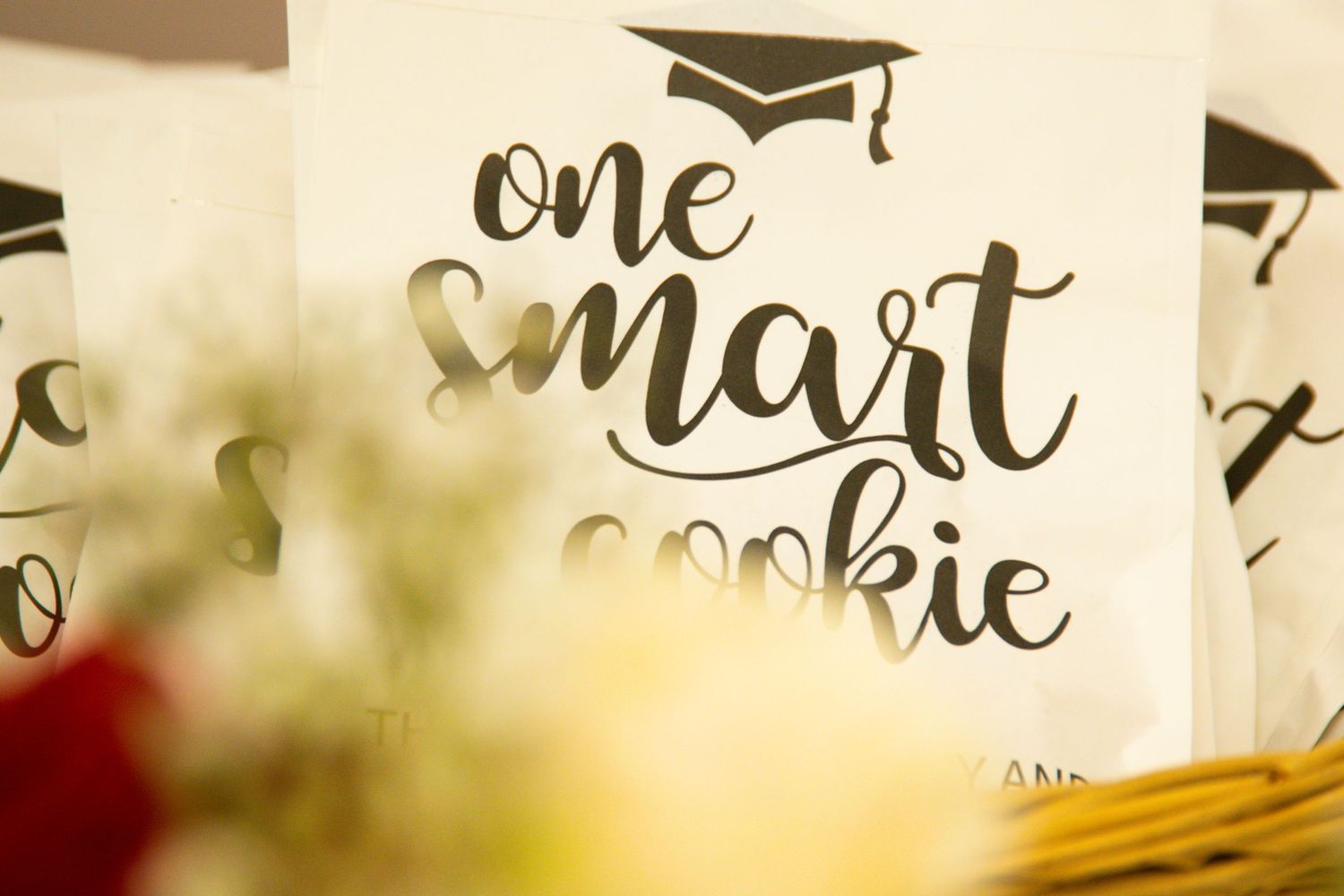 Graduation-themed decorative text with mortarboard icons in elegant script style.