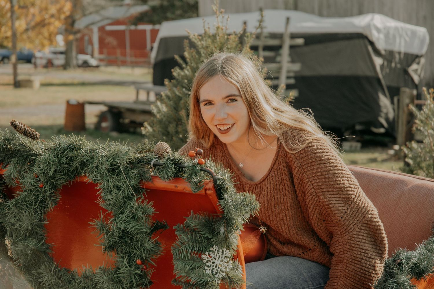 Autumn outdoor portrait session with rustic wooden fence background.