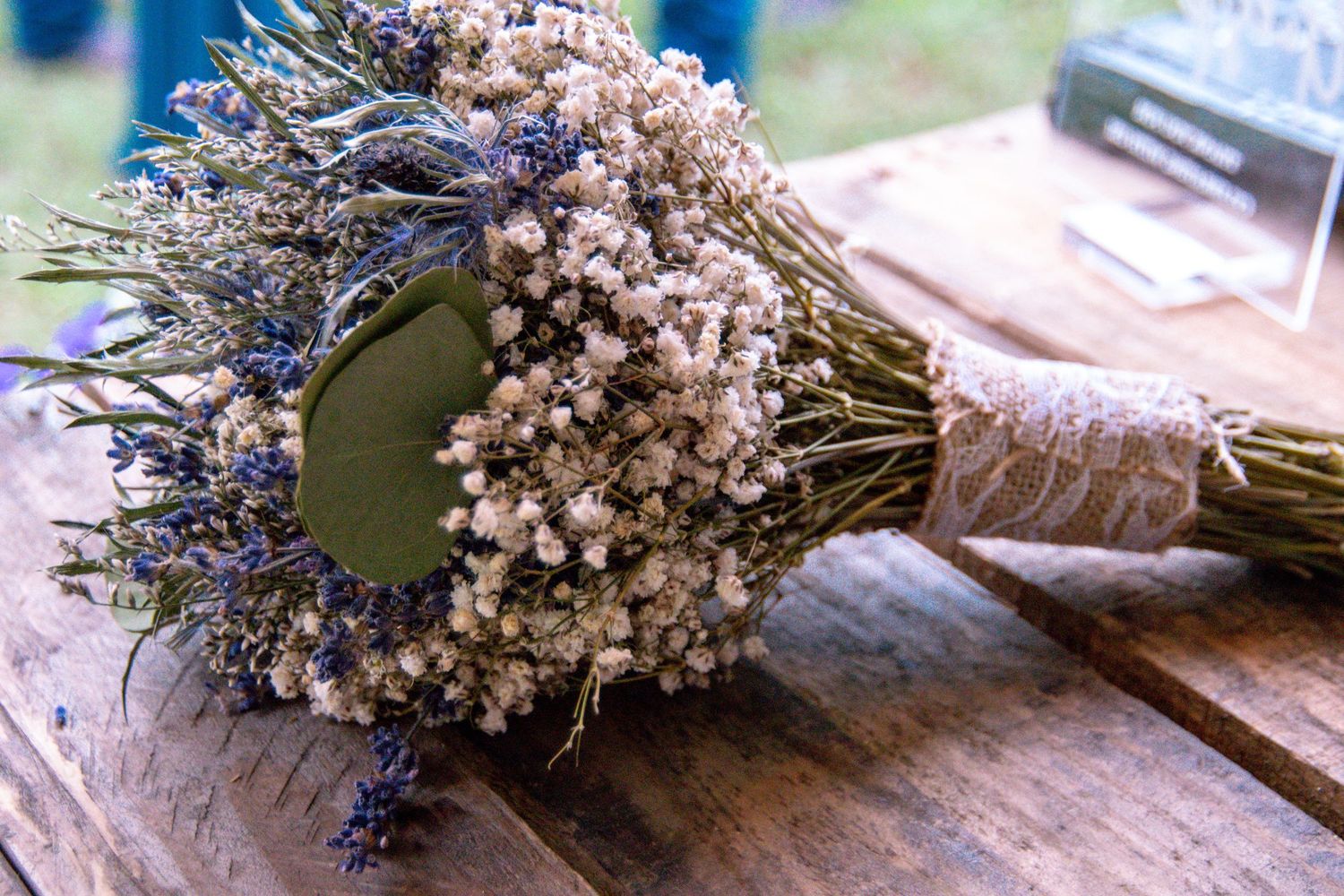 Dried lavender and baby's breath bouquet arranged on wooden surface.