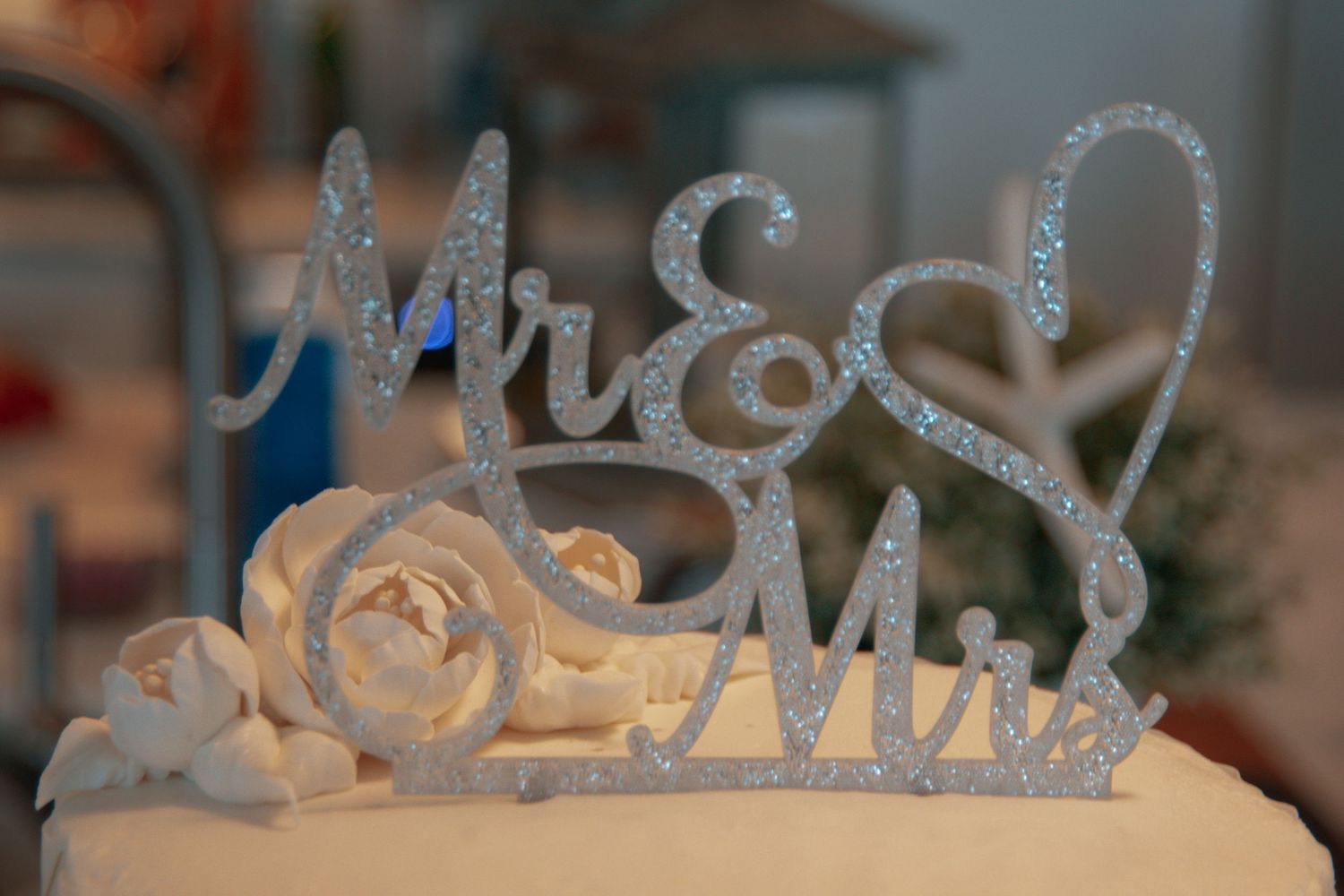 Elegant silver glitter wedding signage displayed at reception.
