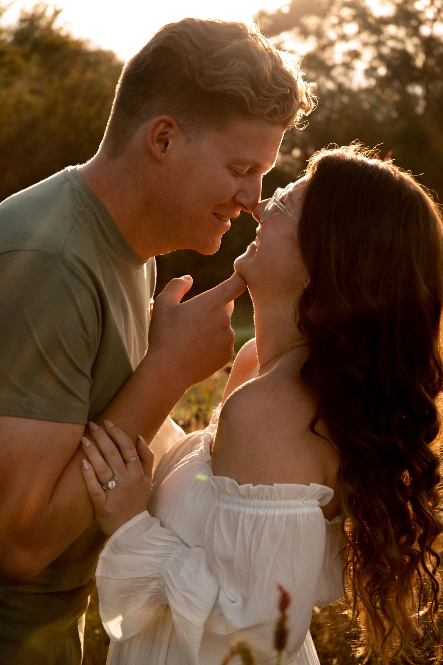 Intimate sunset portrait with golden hour lighting creating romantic atmosphere.