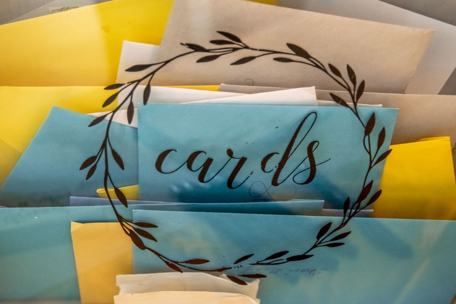 Decorative cards and party supplies in blue and yellow tones arranged on a table.